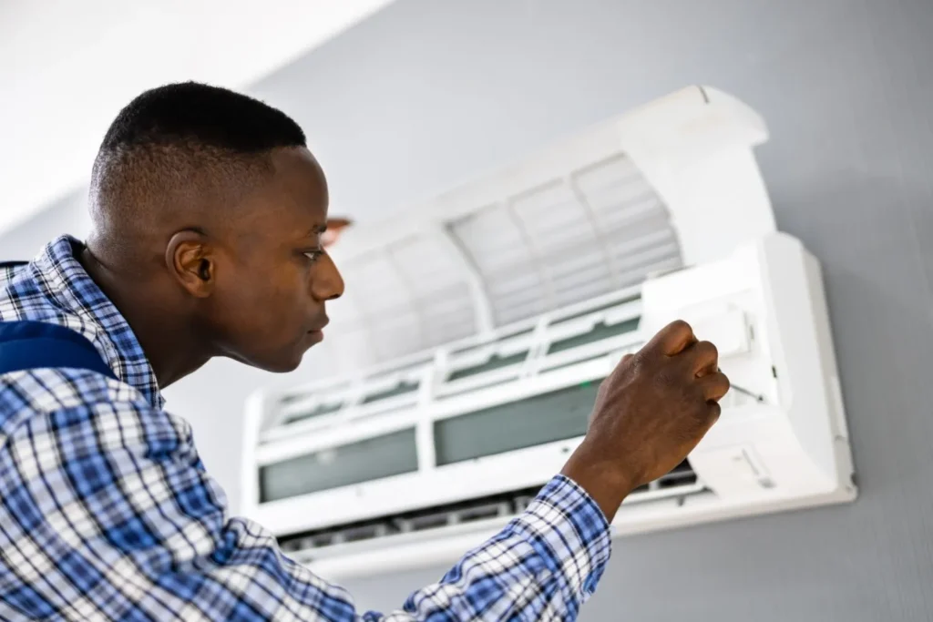 Technician fixing split AC.
